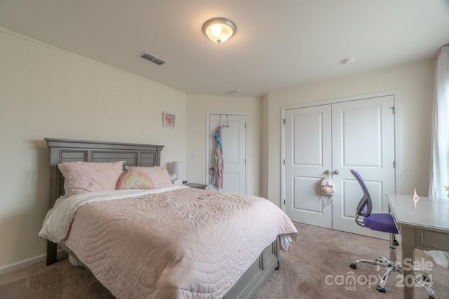 carpeted bedroom featuring multiple closets