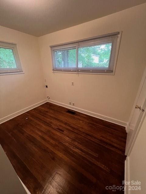 unfurnished room featuring dark wood-type flooring