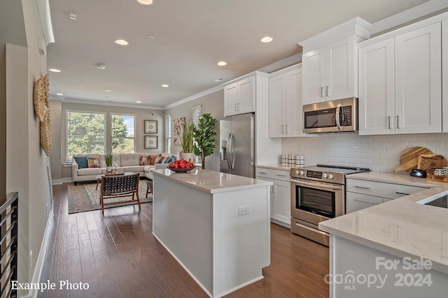 kitchen featuring light stone counters, white cabinets, stainless steel appliances, and dark hardwood / wood-style floors