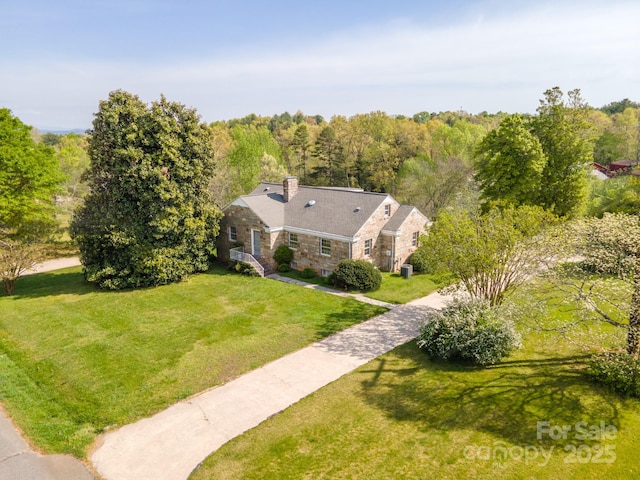 birds eye view of property with a view of trees