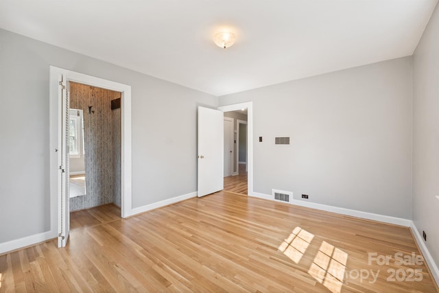 unfurnished bedroom with visible vents, baseboards, and light wood finished floors