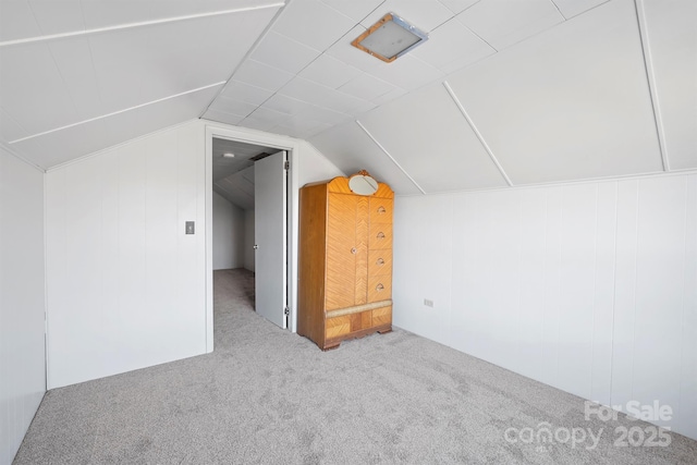 bonus room featuring lofted ceiling and carpet flooring