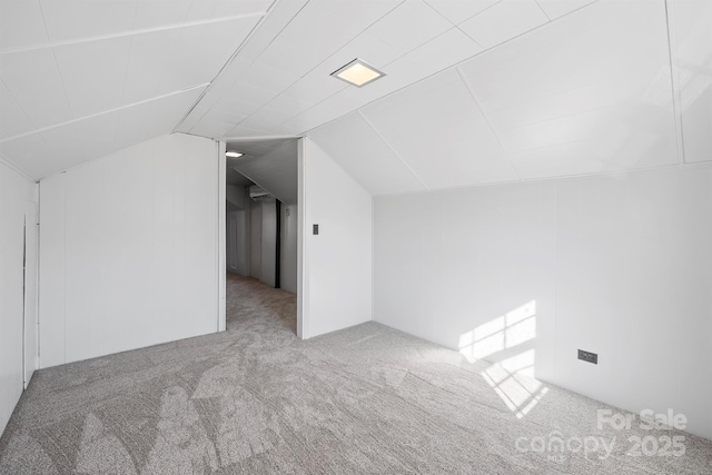 bonus room with lofted ceiling and carpet floors