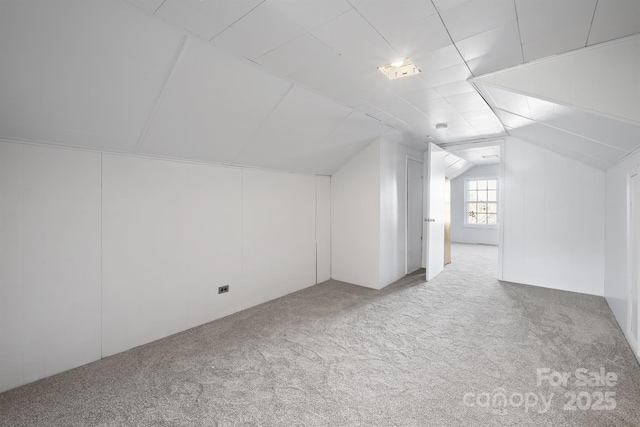 bonus room featuring lofted ceiling and carpet flooring