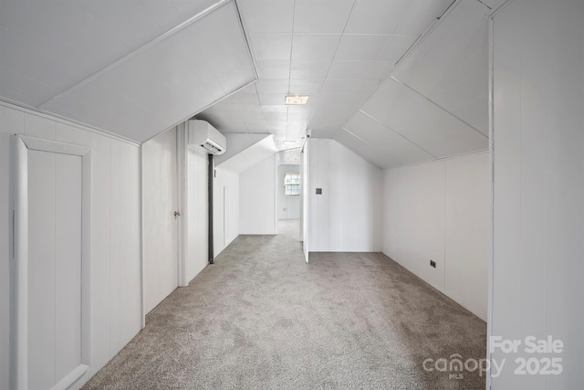 bonus room featuring a wall mounted air conditioner, carpet flooring, and vaulted ceiling