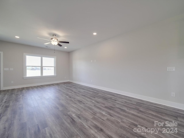 unfurnished room featuring ceiling fan and dark hardwood / wood-style flooring