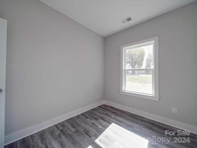 unfurnished room featuring dark wood-type flooring