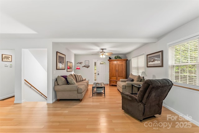 living room with beam ceiling and light hardwood / wood-style flooring