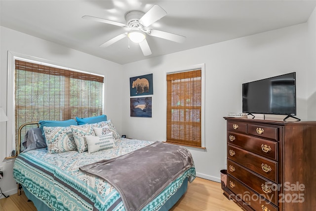 bedroom with ceiling fan and light wood-type flooring