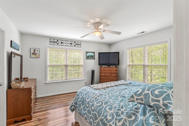 bedroom with hardwood / wood-style floors and ceiling fan