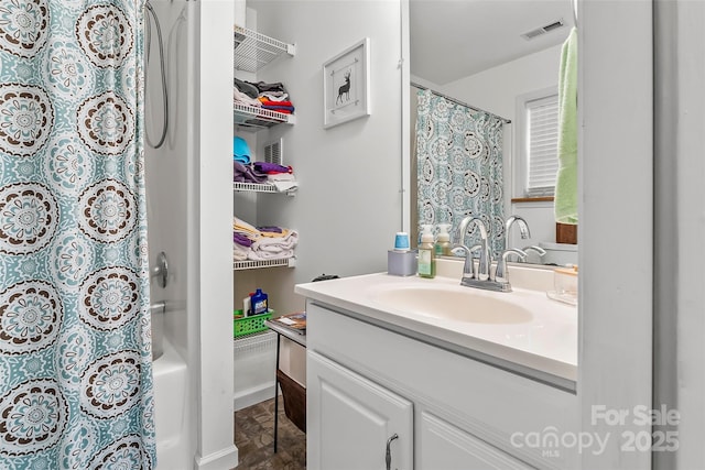 bathroom featuring vanity and shower / tub combo