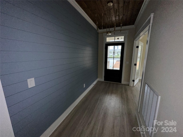 entryway with crown molding, wood ceiling, dark hardwood / wood-style flooring, and wooden walls