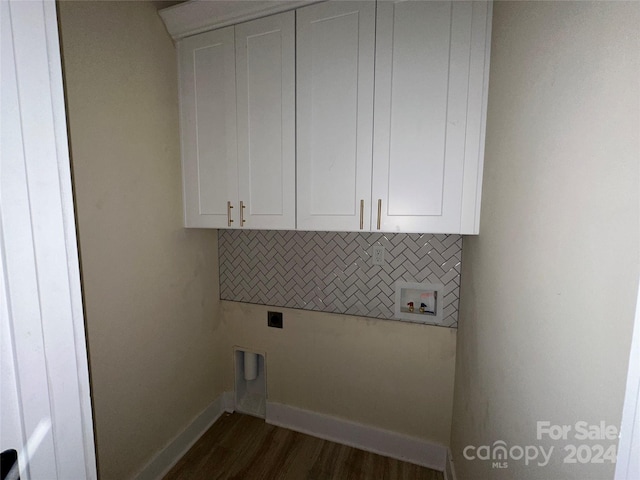 laundry room featuring cabinets, dark hardwood / wood-style floors, and hookup for an electric dryer