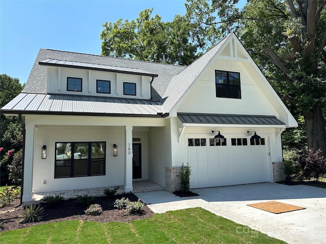 modern farmhouse with covered porch and a garage