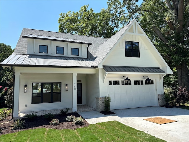 modern farmhouse with a garage and a porch