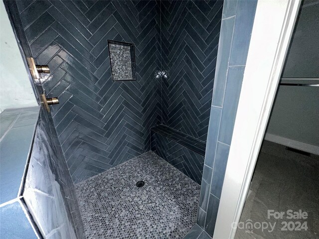 bathroom with a tile shower