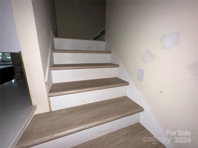 stairs with hardwood / wood-style flooring