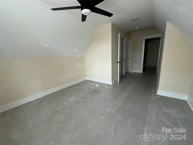 bonus room with lofted ceiling and carpet flooring