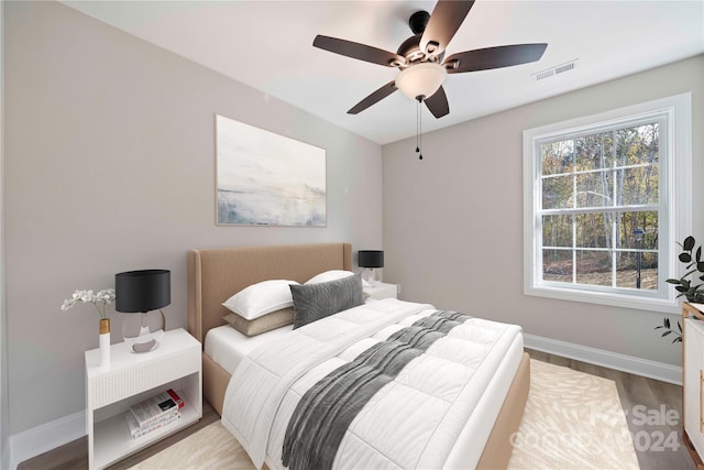 bedroom with ceiling fan and wood-type flooring