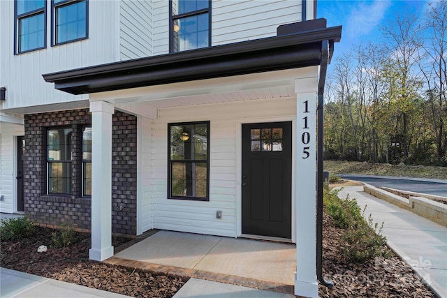 view of exterior entry with covered porch