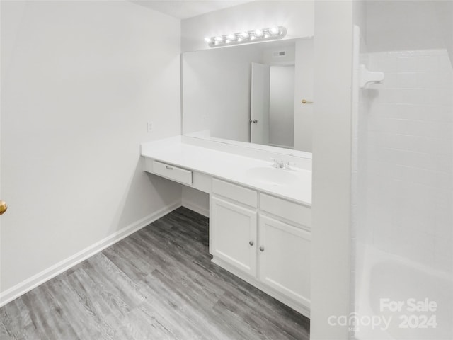 bathroom with wood-type flooring and oversized vanity