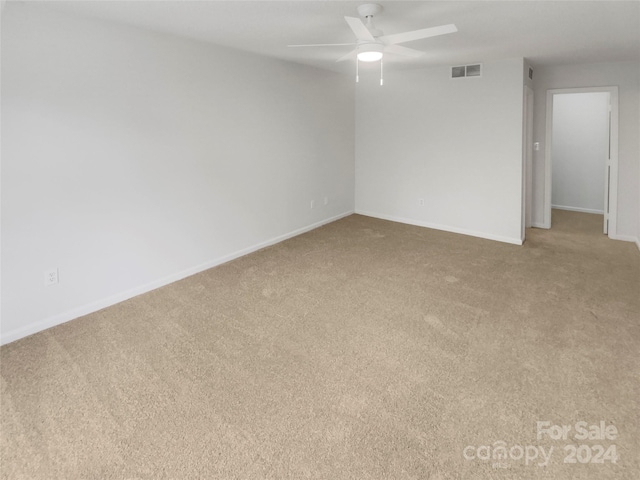 spare room with carpet floors and ceiling fan