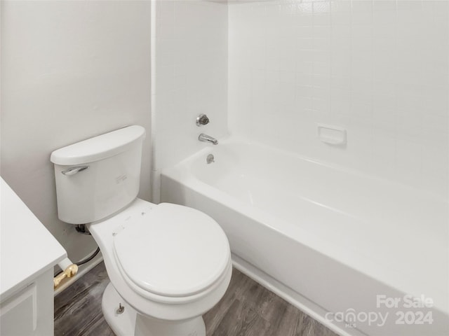 bathroom featuring hardwood / wood-style flooring, toilet, and shower / washtub combination