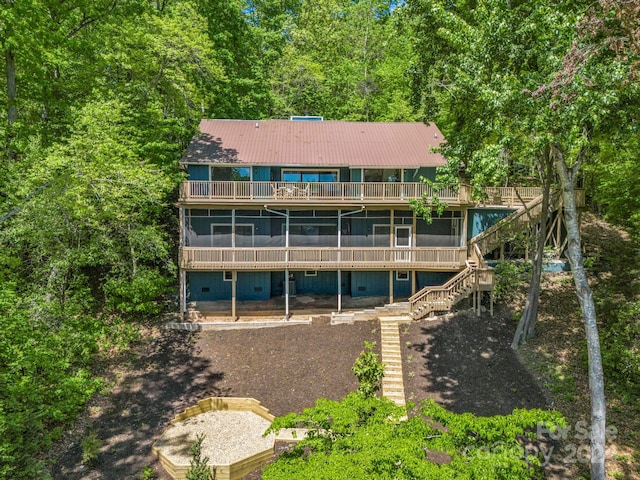 rear view of property featuring a deck