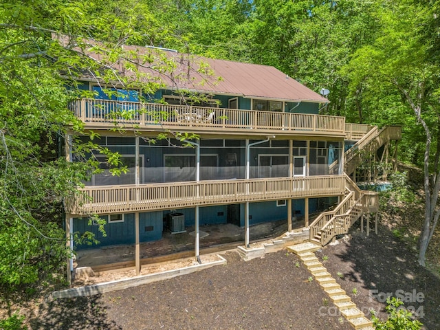 back of house featuring a deck and central air condition unit