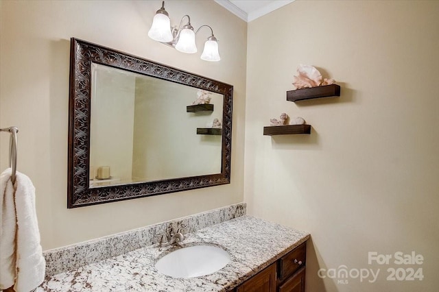 bathroom featuring ornamental molding and vanity