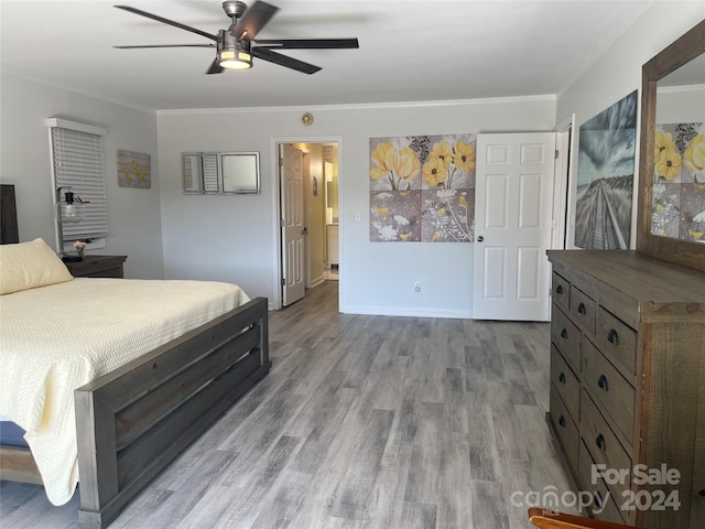 bedroom with ensuite bath, ceiling fan, and hardwood / wood-style floors