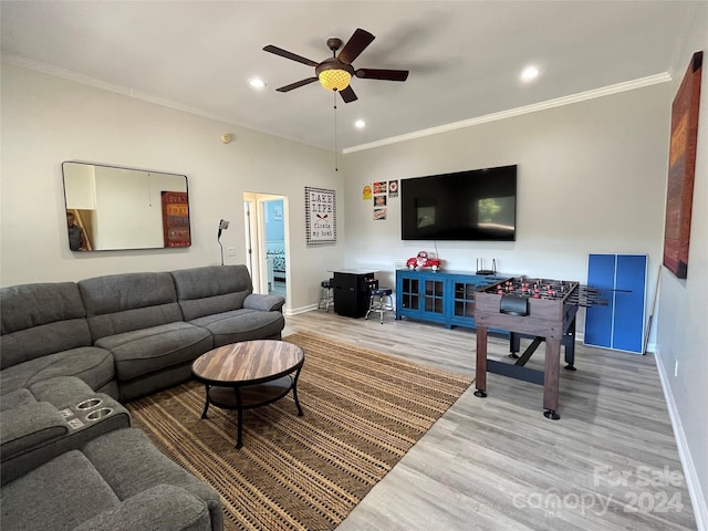 living room with wood-type flooring, ceiling fan, and crown molding