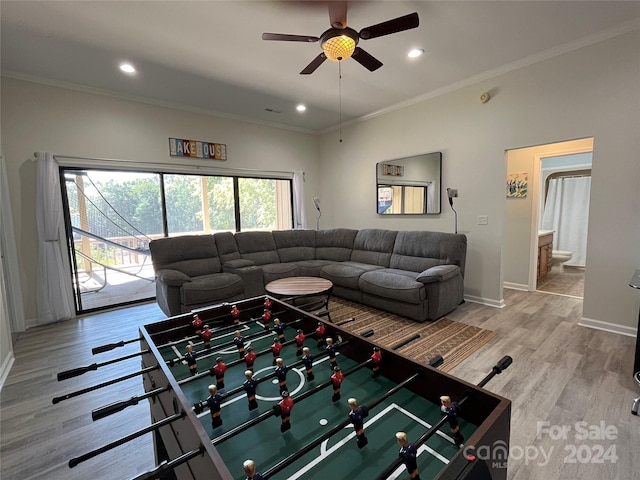 living room featuring ceiling fan, light hardwood / wood-style floors, and ornamental molding