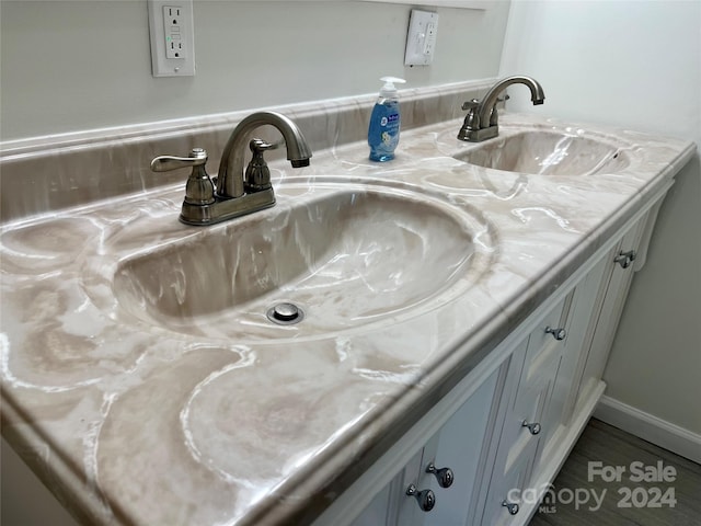 interior space with tile floors and dual vanity