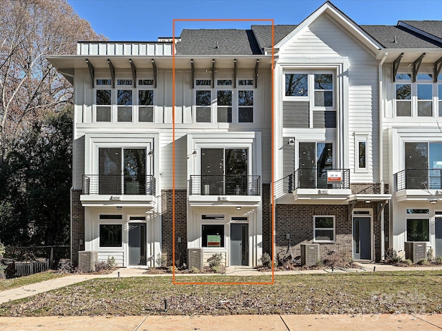 view of front of property with central AC and a balcony