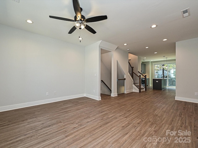 empty room featuring baseboards, visible vents, dark wood-type flooring, and recessed lighting