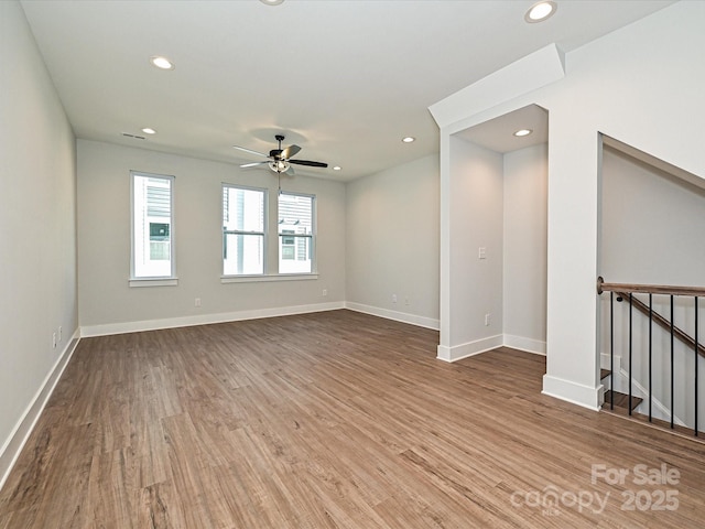 unfurnished room featuring recessed lighting, ceiling fan, baseboards, and wood finished floors