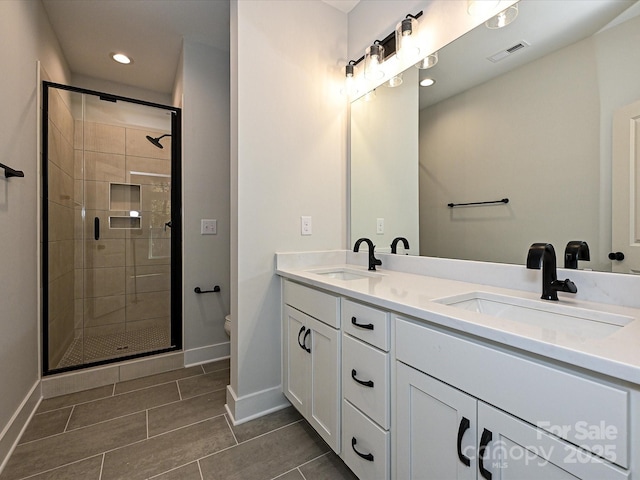 full bath featuring baseboards, a sink, toilet, and double vanity