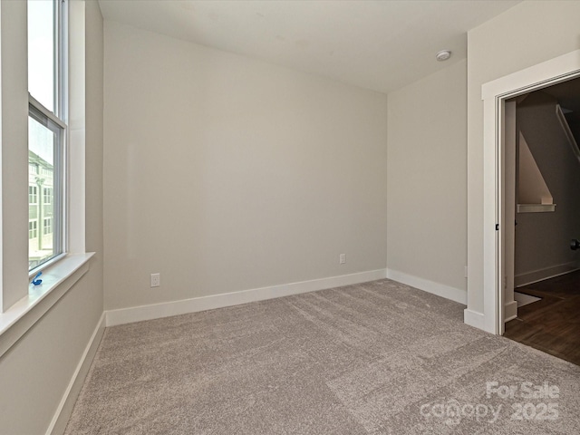 unfurnished bedroom featuring carpet and baseboards