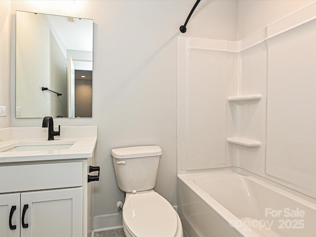 bathroom with baseboards, tub / shower combination, vanity, and toilet