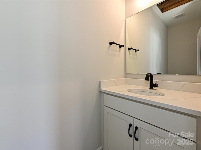 bathroom with visible vents and vanity