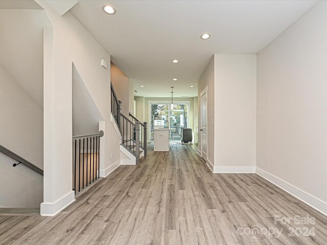 corridor with light hardwood / wood-style floors