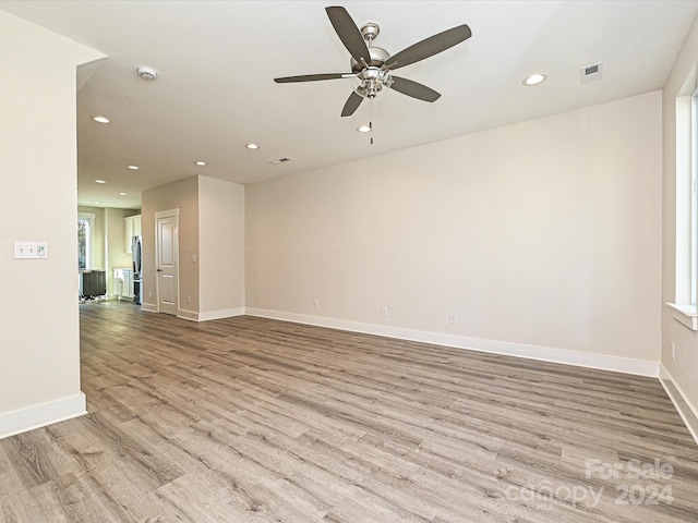 spare room with light wood-type flooring and ceiling fan