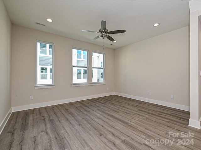 empty room with ceiling fan and dark hardwood / wood-style flooring