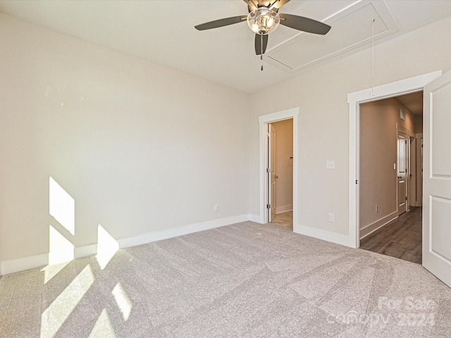 spare room featuring ceiling fan and dark carpet