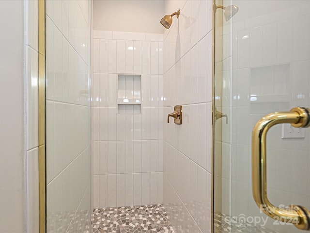 bathroom featuring a shower with door