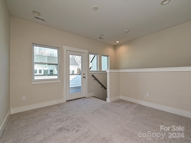 empty room featuring light colored carpet