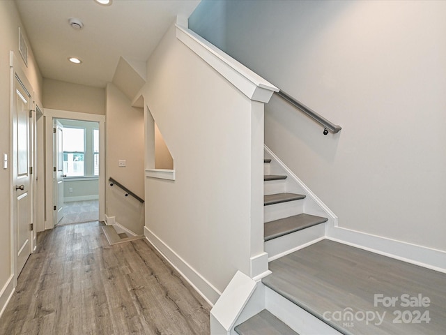 staircase featuring hardwood / wood-style floors