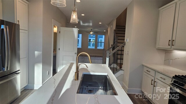 1217 E 34th St Unit Csw0316, Charlotte, NC 28205 - kitchen featuring a sink, ceiling fan, baseboards, appliances with stainless steel finishes, and recessed lighting