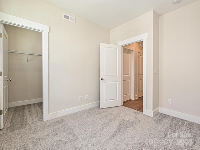 unfurnished bedroom with a closet and carpet